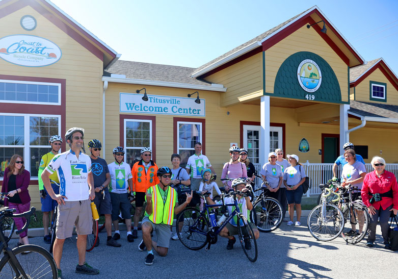 Bike riders from the East Coast Greenway Tour pose outside of Titusville's downtown Welcome Center on November 17, 2018.